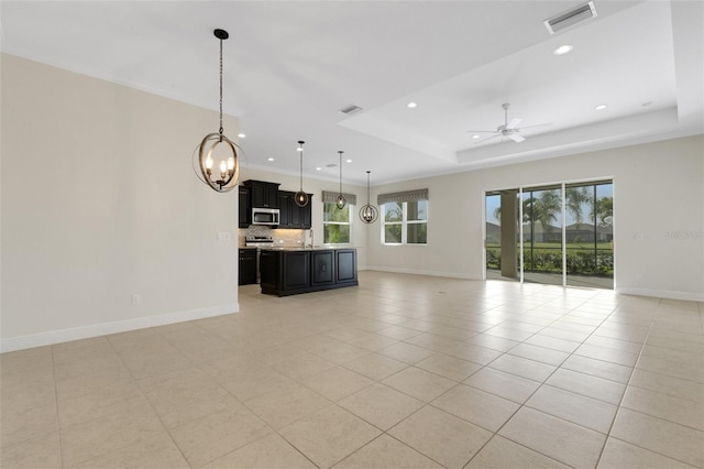 13789 Old Creek Ct, Parrish, FL 34219 - unfurnished living room with recessed lighting, light tile patterned flooring, ceiling fan, a tray ceiling, and a chandelier