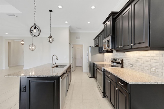 13789 Old Creek Ct, Parrish, FL 34219 - kitchen featuring appliances with stainless steel finishes, crown molding, backsplash, an island with sink, and light tile patterned flooring