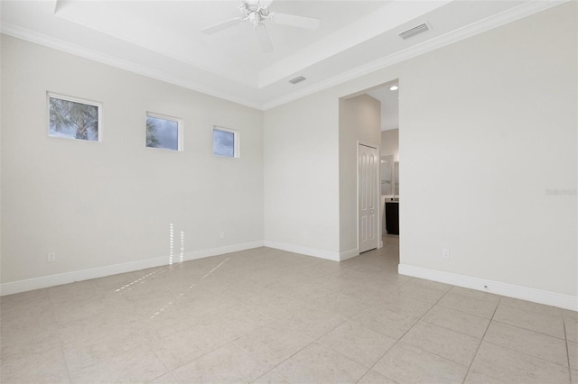 13789 Old Creek Ct, Parrish, FL 34219 - spare room featuring a tray ceiling, a ceiling fan, crown molding, and light tile patterned floors