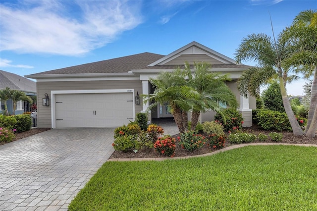 13789 Old Creek Ct, Parrish, FL 34219 - ranch-style home with decorative driveway, a front yard, and a garage