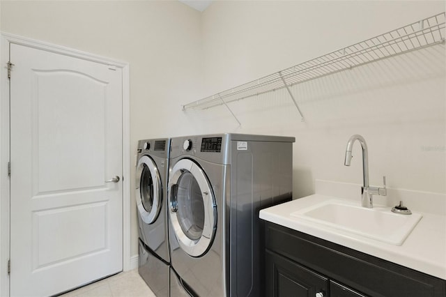 13789 Old Creek Ct, Parrish, FL 34219 - laundry room featuring washing machine and clothes dryer, cabinet space, and light tile patterned flooring