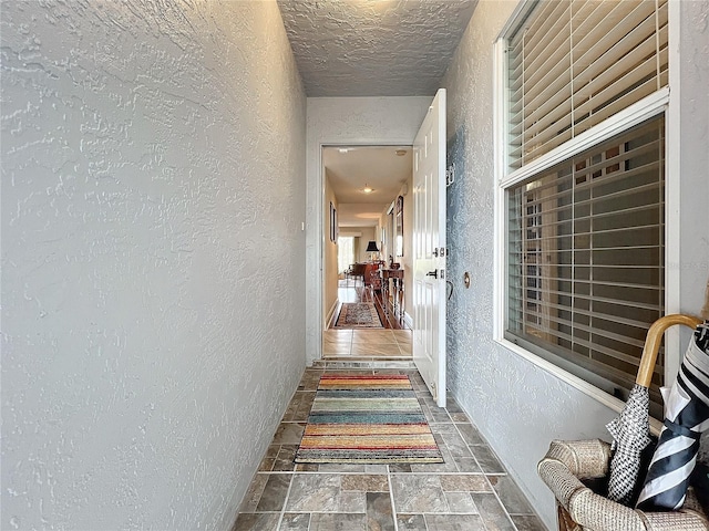 corridor with a textured ceiling