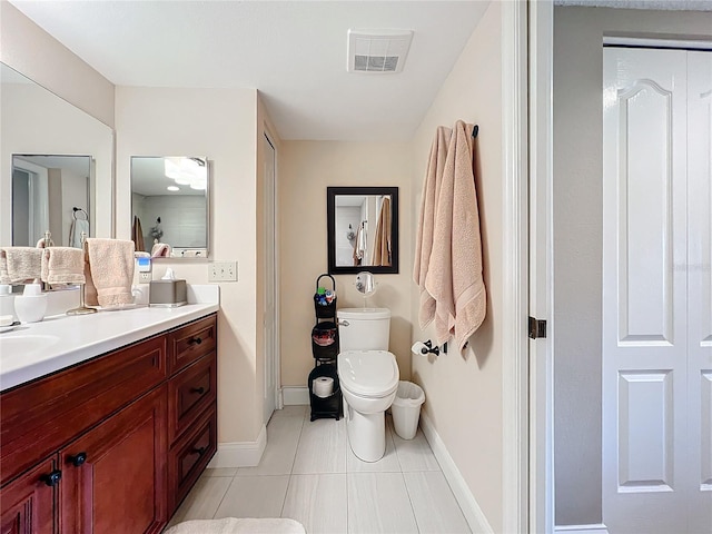 bathroom with tile patterned floors, vanity, and toilet