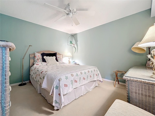 bedroom with ceiling fan and light carpet