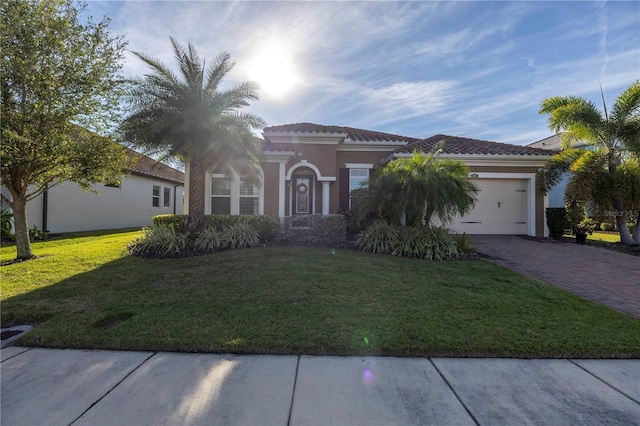 mediterranean / spanish-style home with a front lawn and a garage