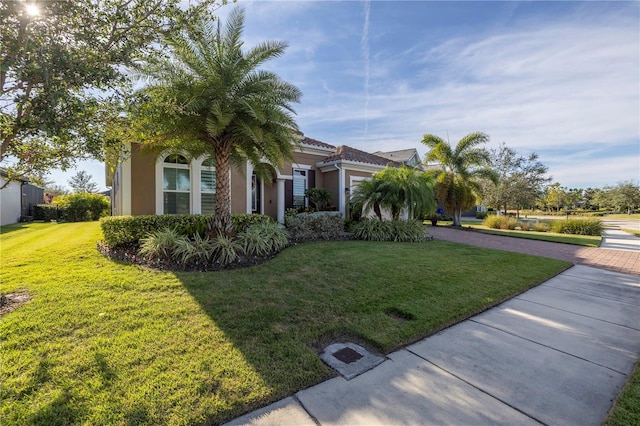 view of property hidden behind natural elements with a front yard