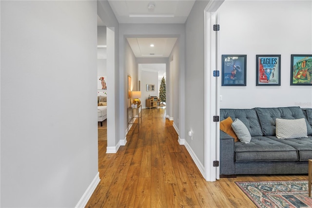 corridor with light hardwood / wood-style floors