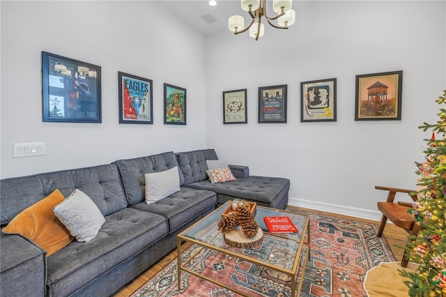 living room with hardwood / wood-style floors and an inviting chandelier