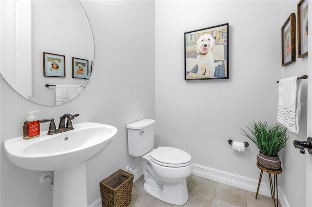 bathroom featuring sink, tile patterned flooring, and toilet