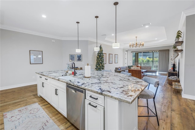 kitchen featuring sink, white cabinetry, stainless steel dishwasher, and an island with sink