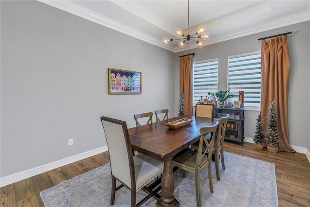 dining space with a chandelier, wood-type flooring, and crown molding