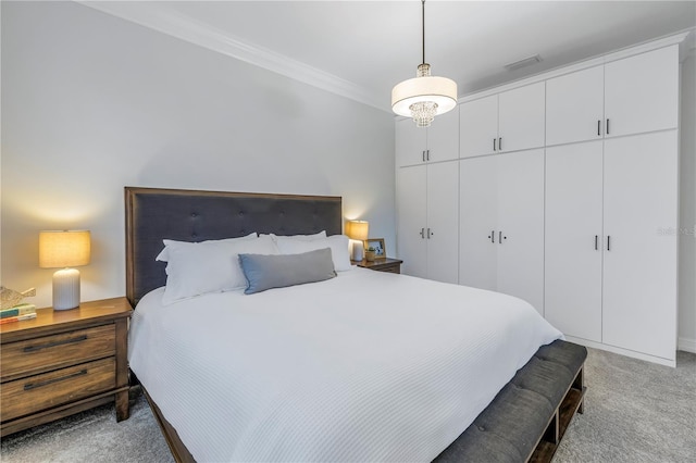 bedroom with crown molding, a closet, and light colored carpet