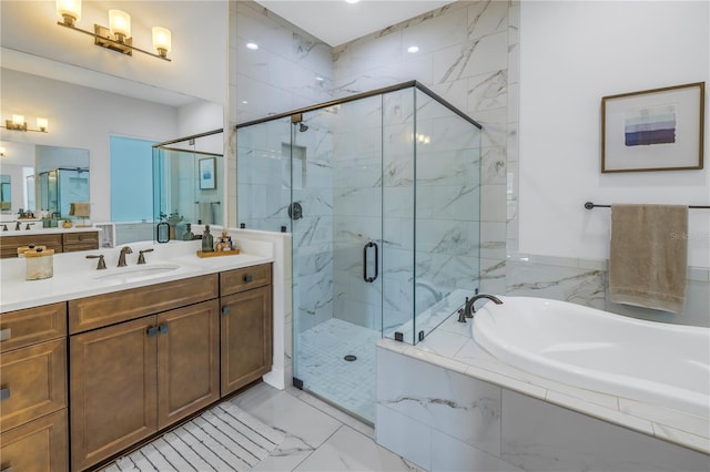 bathroom featuring vanity and shower with separate bathtub