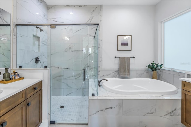 bathroom featuring vanity and separate shower and tub