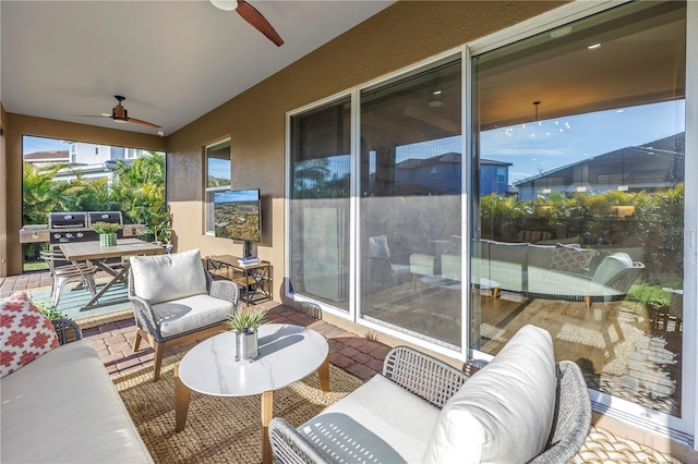 sunroom / solarium featuring ceiling fan