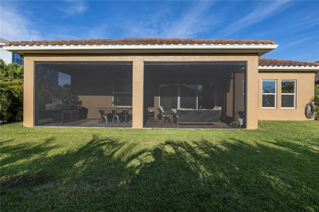 rear view of property featuring a yard