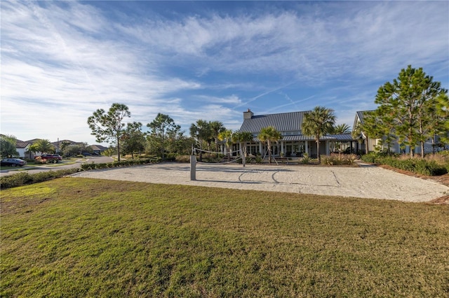 view of community with a yard and volleyball court