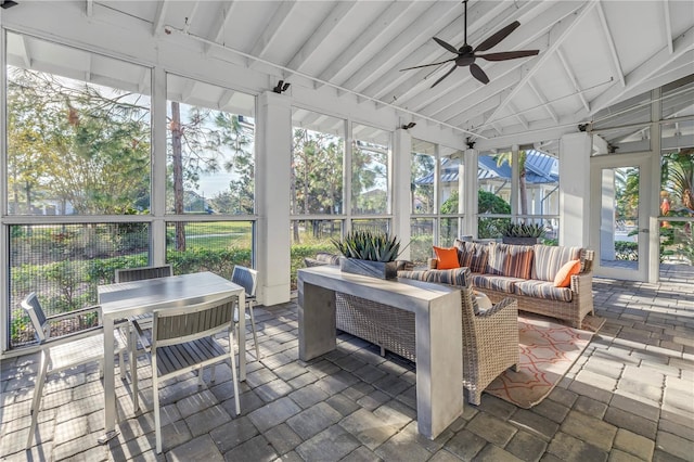 sunroom with ceiling fan and lofted ceiling