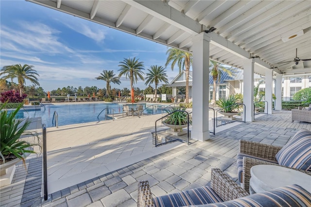 view of patio / terrace with ceiling fan and a community pool