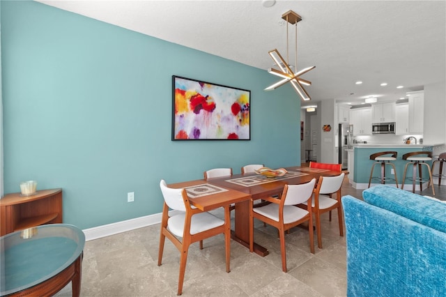 dining area featuring a textured ceiling and an inviting chandelier