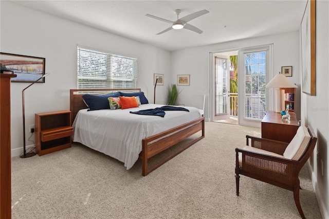 bedroom featuring multiple windows, ceiling fan, light carpet, and access to exterior