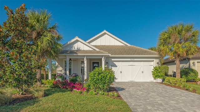 view of front of property with a front lawn and a garage