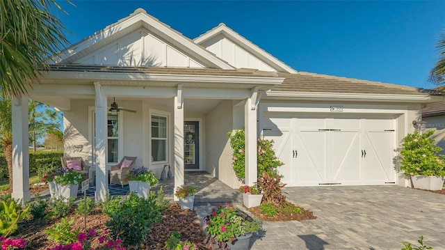 view of front of home featuring a porch and a garage