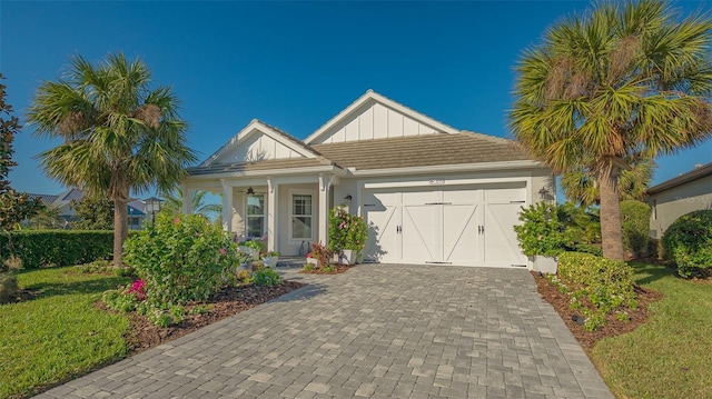 view of front of home with a garage and a front lawn