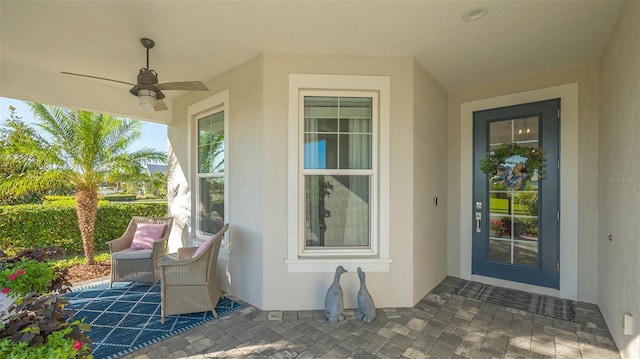 entrance to property featuring ceiling fan