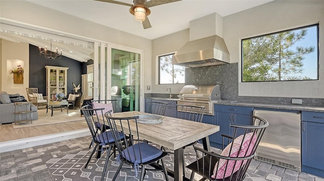 interior space featuring a grill, ceiling fan, sink, and an outdoor kitchen