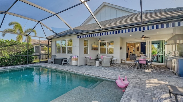 back of house with glass enclosure, ceiling fan, and a patio area