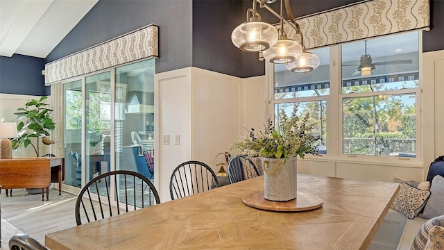 dining space with ceiling fan and lofted ceiling