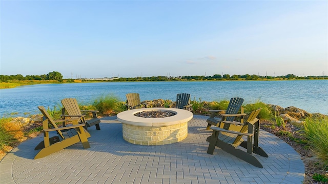 view of patio / terrace featuring a water view and a fire pit