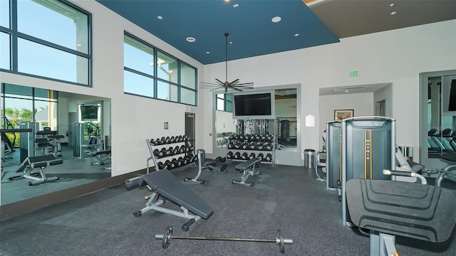 gym featuring a high ceiling and ceiling fan