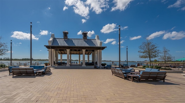 surrounding community featuring outdoor lounge area, a gazebo, and a water view