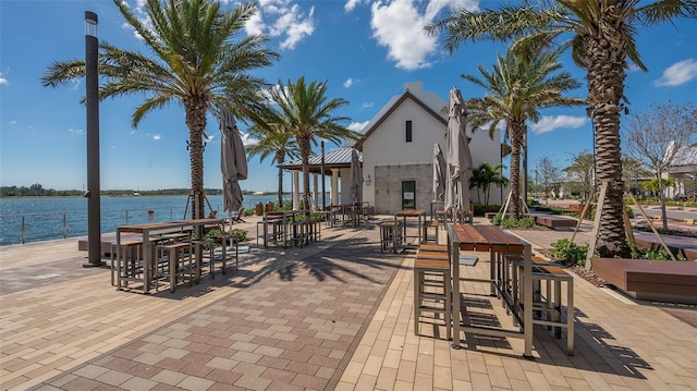 view of patio / terrace featuring a water view and an outdoor bar