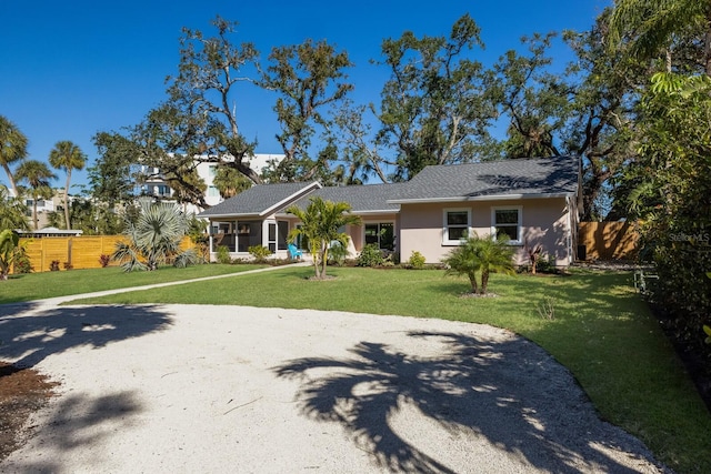 ranch-style home with a front yard