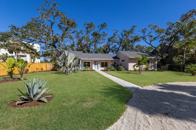 single story home with a front lawn