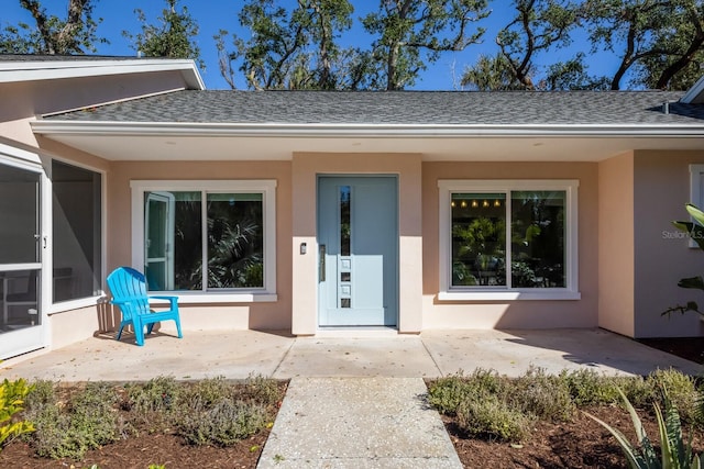 view of exterior entry featuring a patio area