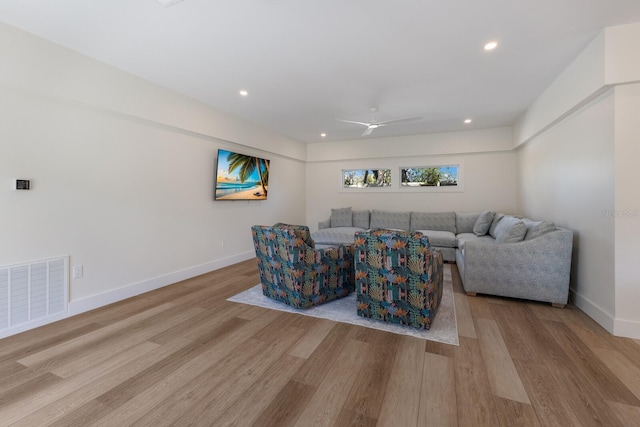 living room with ceiling fan and light wood-type flooring