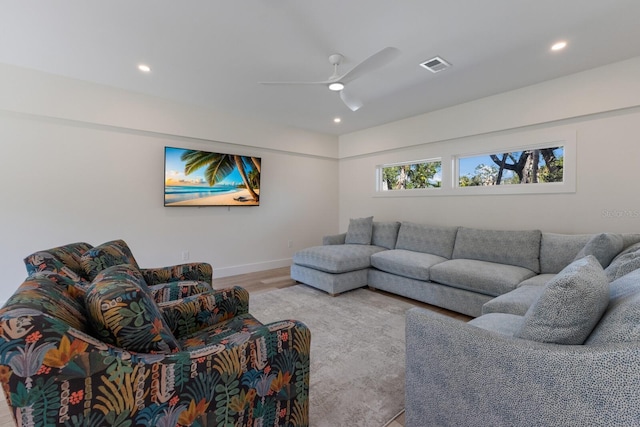 living room with ceiling fan and light hardwood / wood-style floors