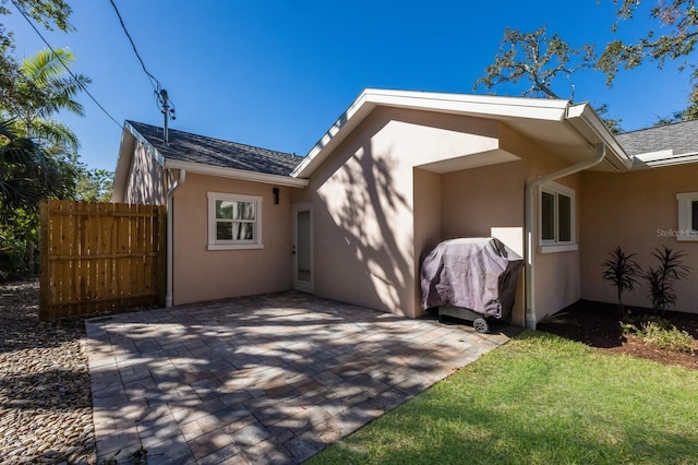 back of property with a patio