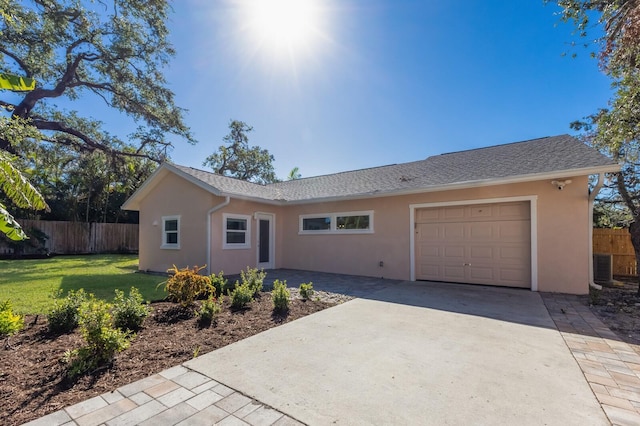 single story home with central air condition unit, a front lawn, and a garage