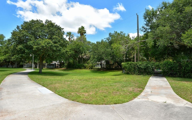 view of property's community featuring a yard