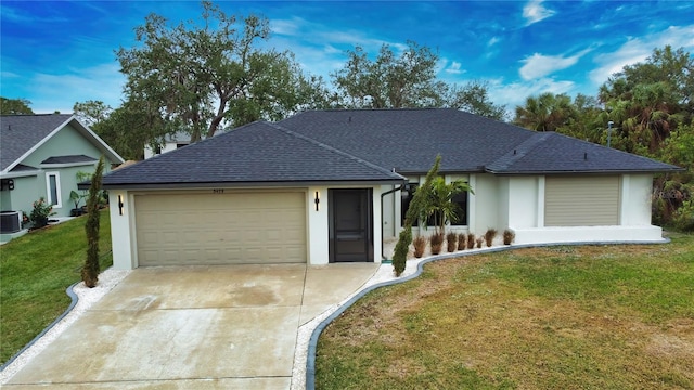 single story home featuring central air condition unit, a front yard, and a garage