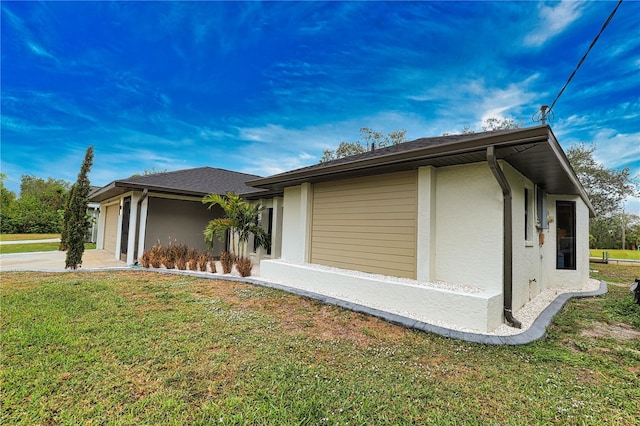 view of property exterior with a yard and a garage