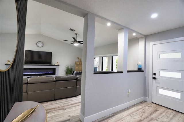 entrance foyer featuring light wood-type flooring, vaulted ceiling, and ceiling fan