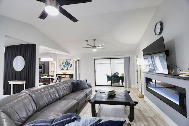 living room with light wood-type flooring and lofted ceiling