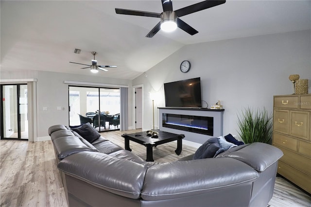 living room with light hardwood / wood-style flooring, ceiling fan, and lofted ceiling