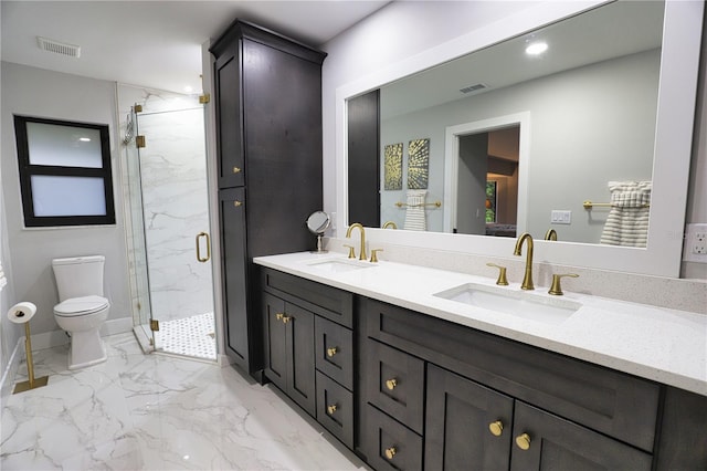 bathroom featuring vanity, toilet, and a shower with shower door